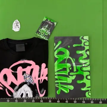 Syna World Tees QC photo